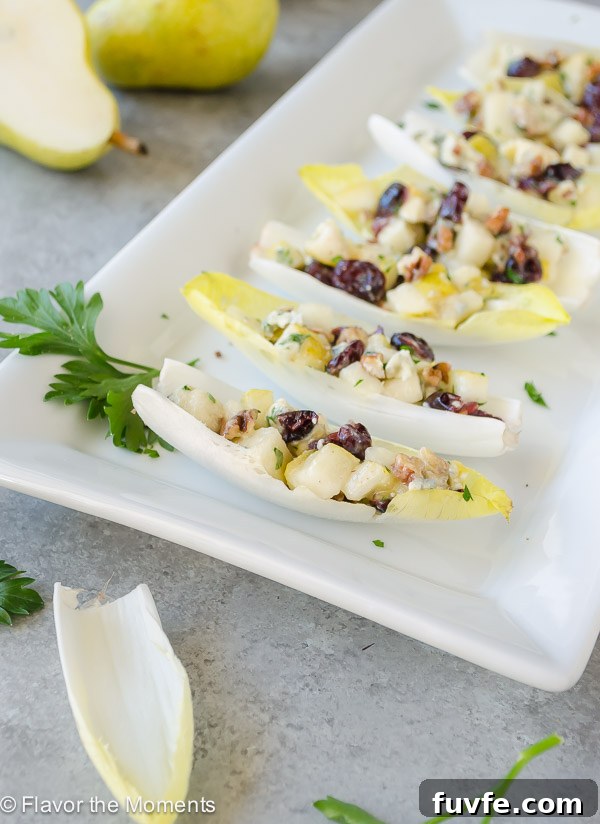 Endive salad bites on white platter with parsley