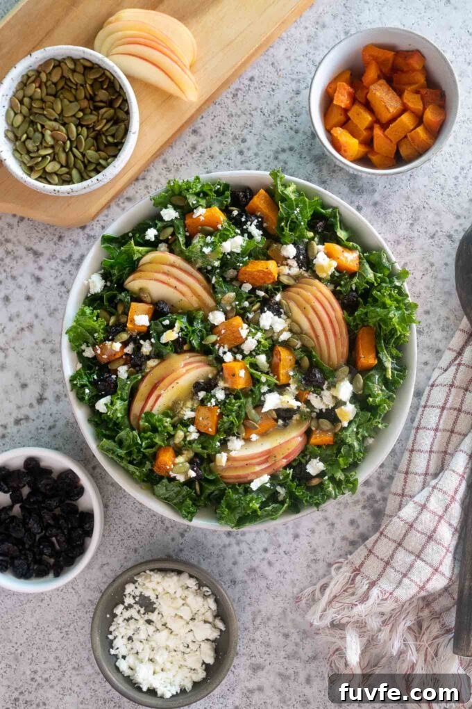 fall harvest salad in a bowl with toppings alongside