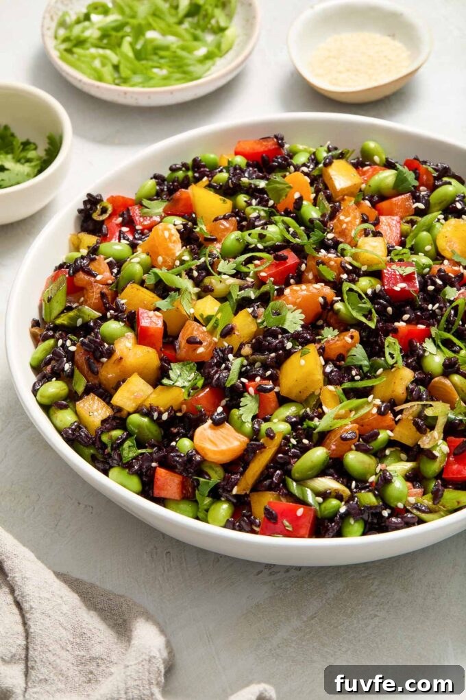 Asian rice salad in a white serving bowl.