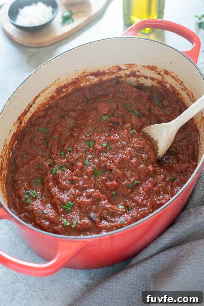 Homemade meat sauce in a Dutch oven with parsley