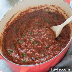 Classic Homemade Meat Sauce Recipe for Pasta 9 Homemade meat sauce in a Dutch oven with parsley