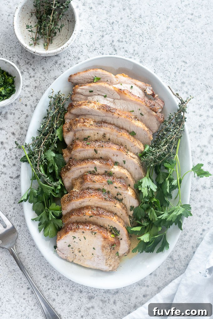 Roasted Pork Loin with Garlic and Rosemary 3 Pork loin roast on a platter with fresh parsley