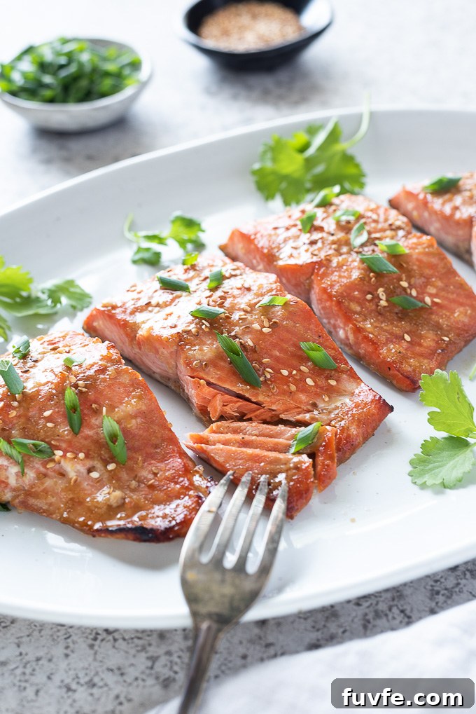Miso-Glazed Salmon Recipe with Sesame and Scallions 5 Miso marinated salmon on a platter with fork flaking fish