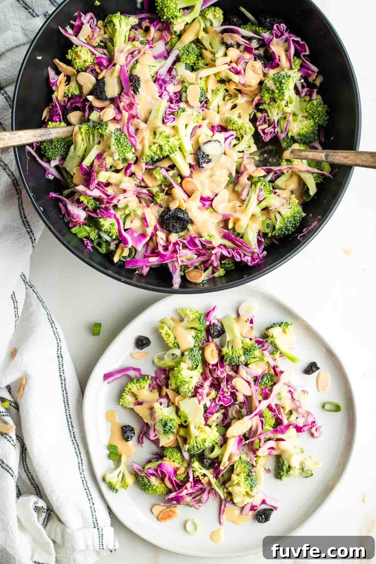 Broccoli salad with cabbage, almonds, scallions and miso dressing in a serving bowl and on a plate.
