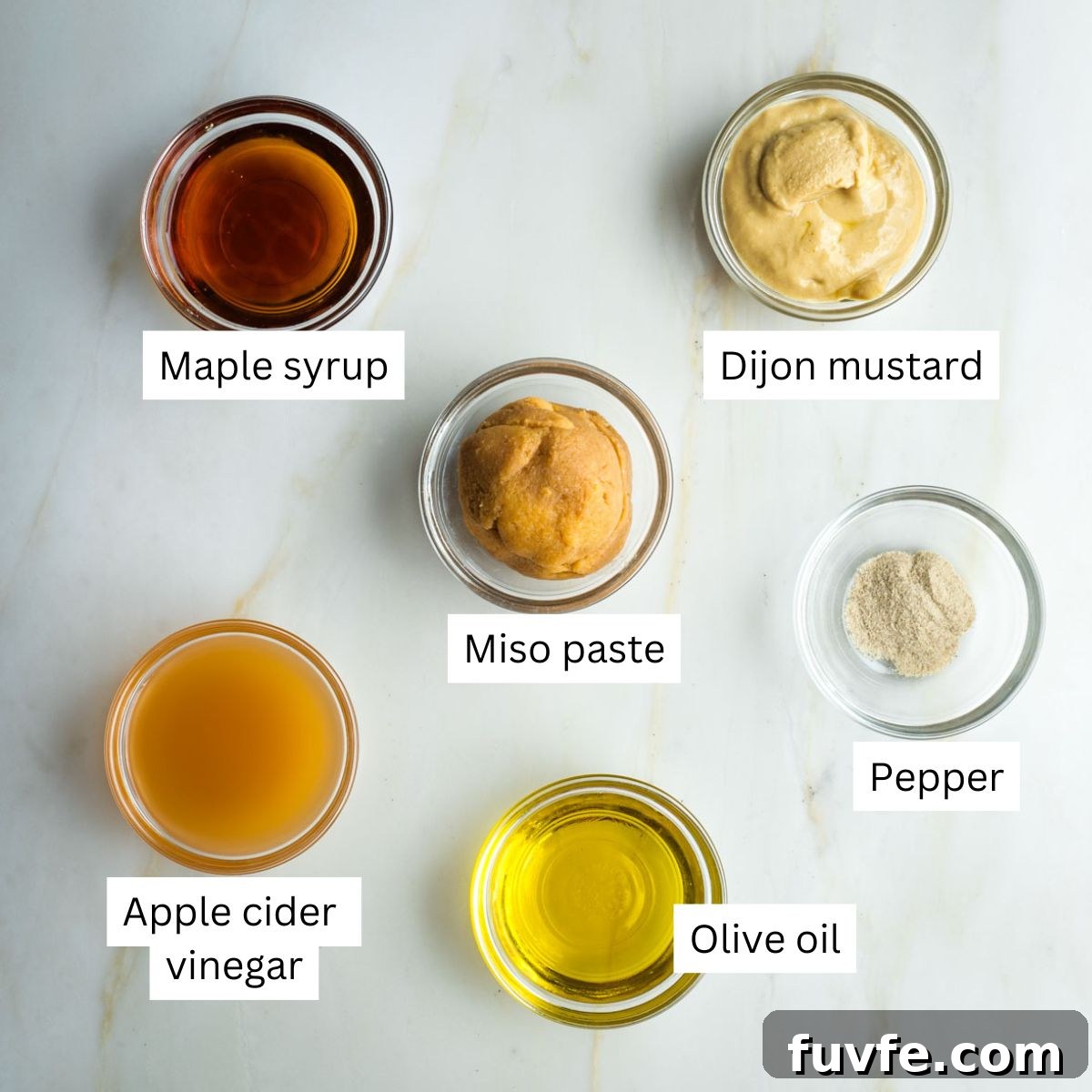 Labeled ingredients for miso dressing on a broccoli salad.