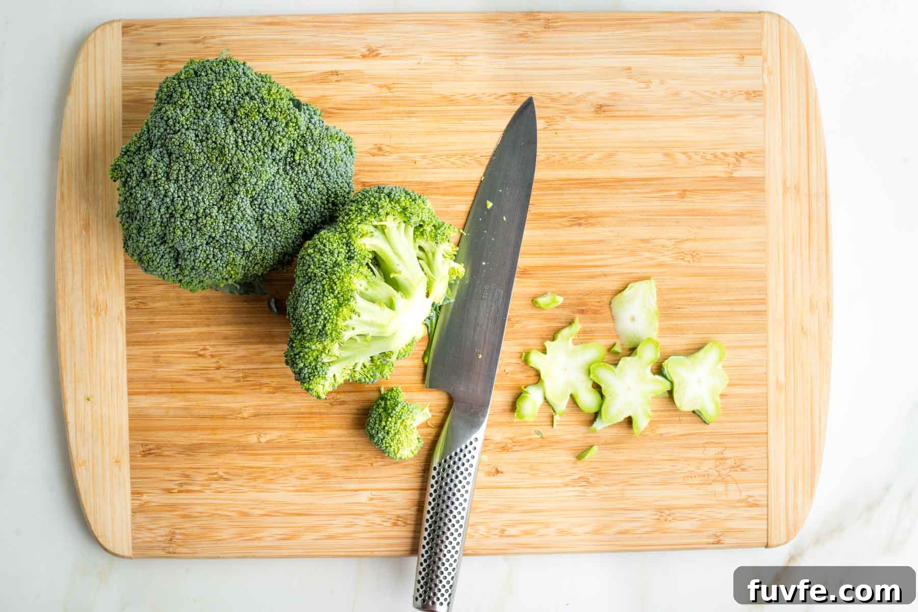 Trimming stems off broccoli crowns.