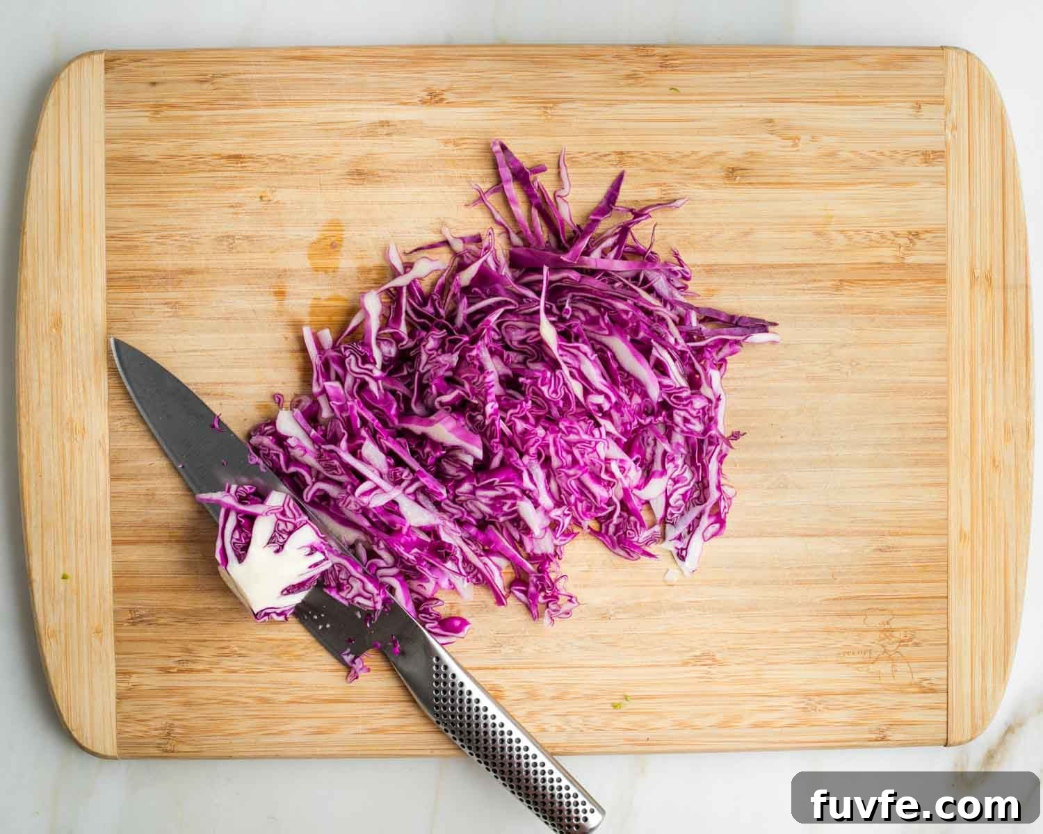 Taking ¼ head red cabbage into 1 cup shredded with thin slices and a sharp knife.