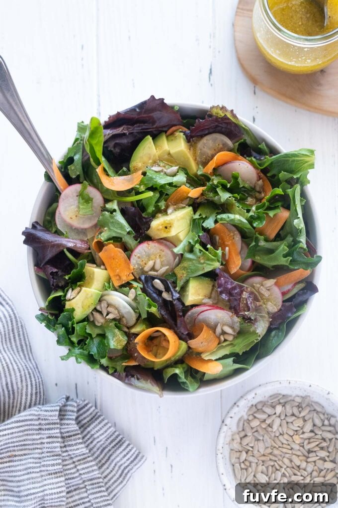 Spring Mix Salad Recipe: Fresh Greens with Lemon Vinaigrette 2 Spring mix salad in a bowl with serving spoon