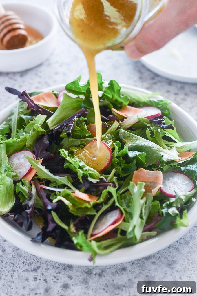Homemade Honey Mustard Dressing: Creamy Tangy Recipe 6 Honey and mustard dressing pouring over a salad
