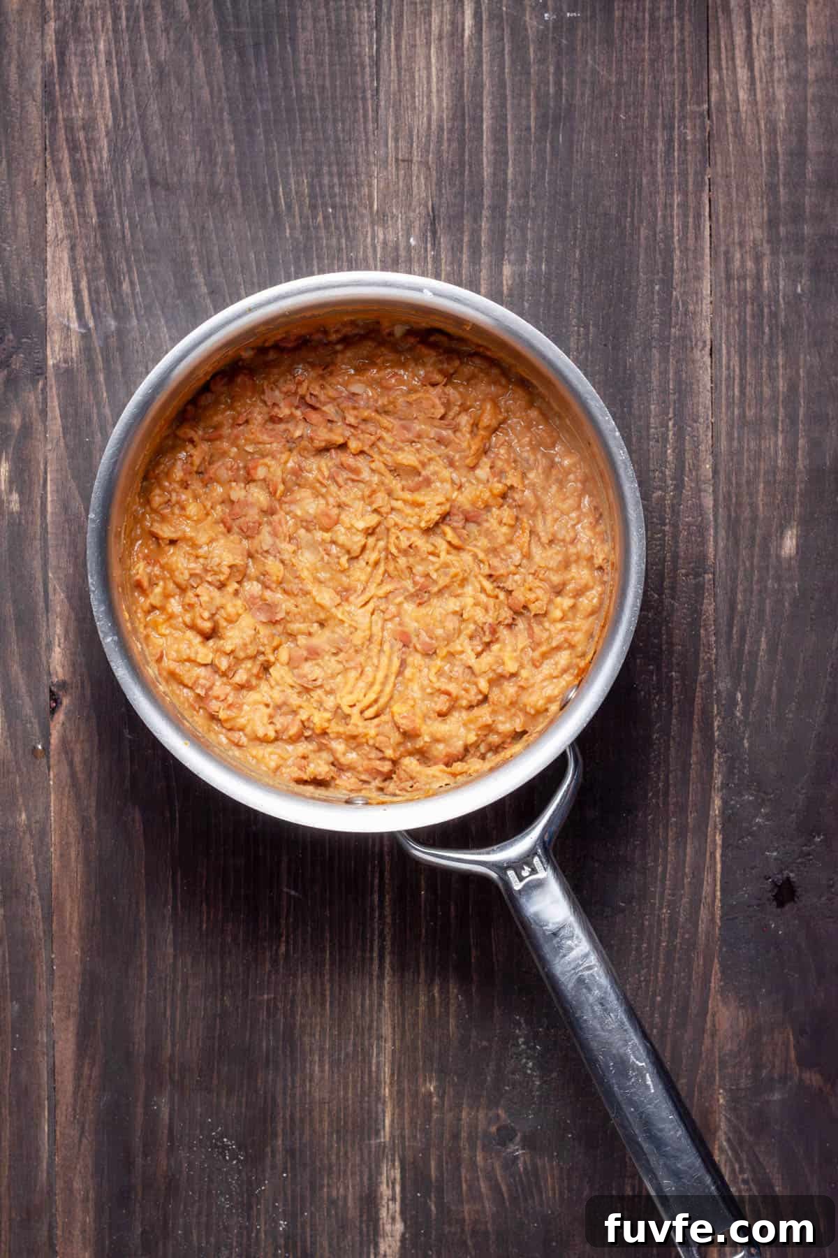 Vegan refried beans in a medium saucepan.