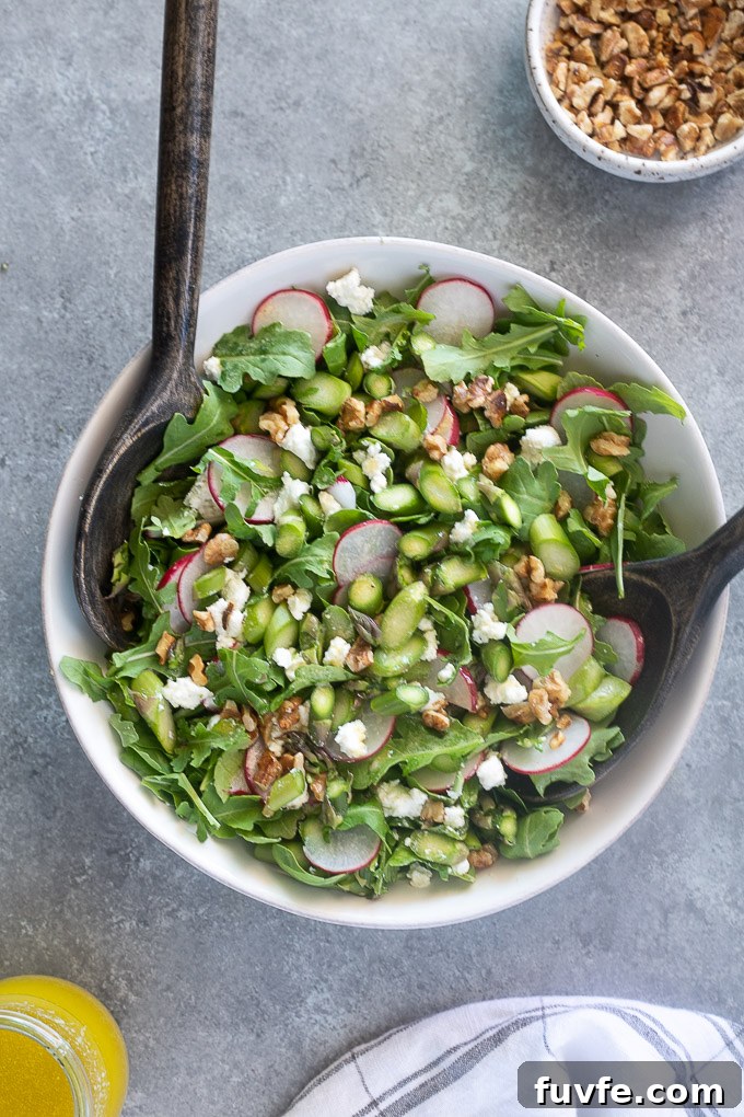 Raw asparagus salad tossed with arugula and goat cheese