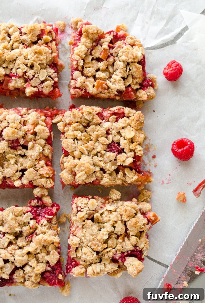 Raspberry rhubarb crisp bars cut into squares.