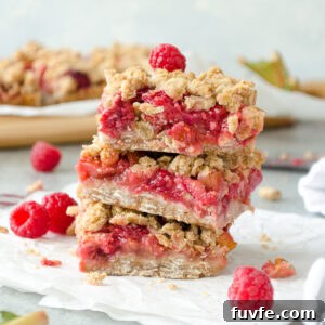 Raspberry Rhubarb Bars with Oat Crumble 6 Stack of raspberry rhubarb oatmeal bars.
