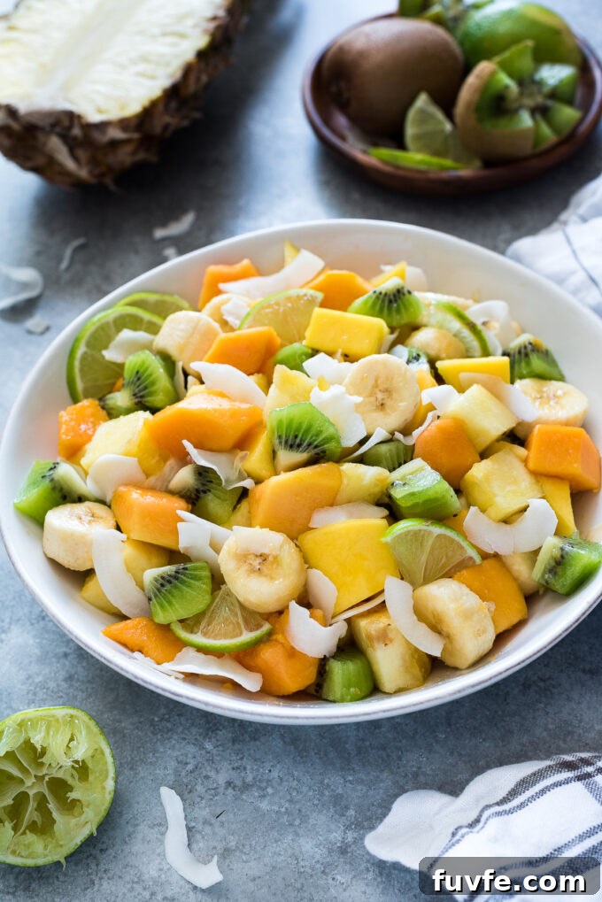 Tropical fruit salad with coconut in a serving bowl.