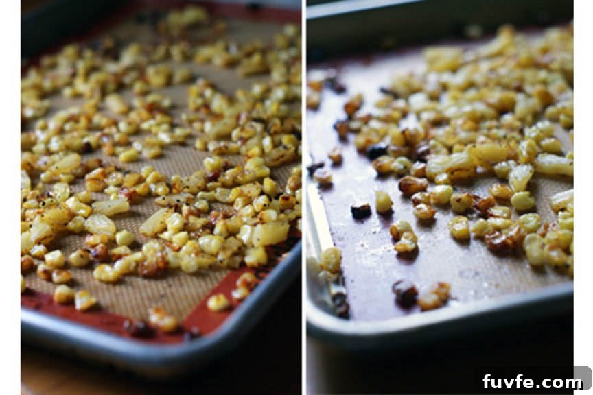 Roasted pineapple and corn on a lined baking sheet.