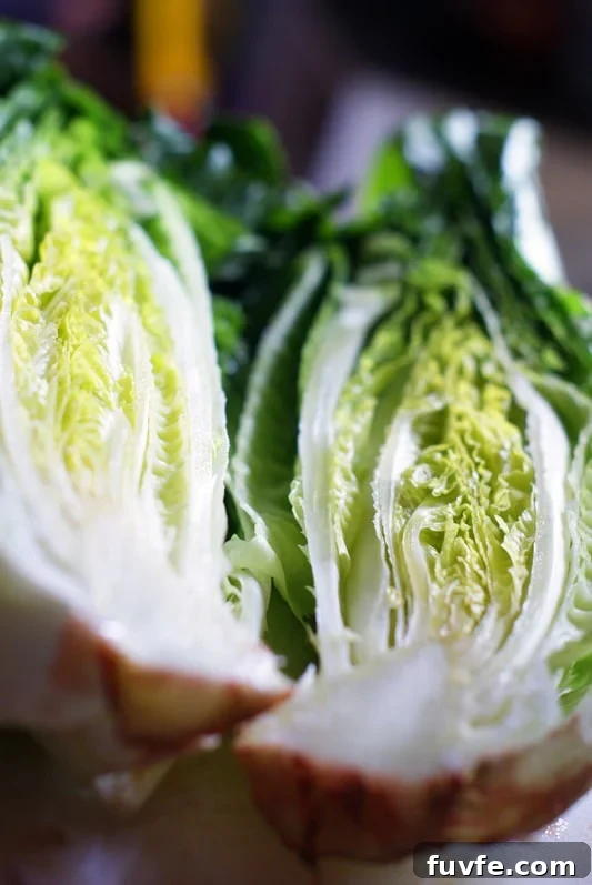 A whole lettuce cut in half.