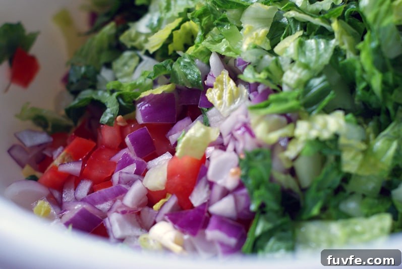 Simple BBQ Chicken Chopped Salad ingredients in a large white bowl.