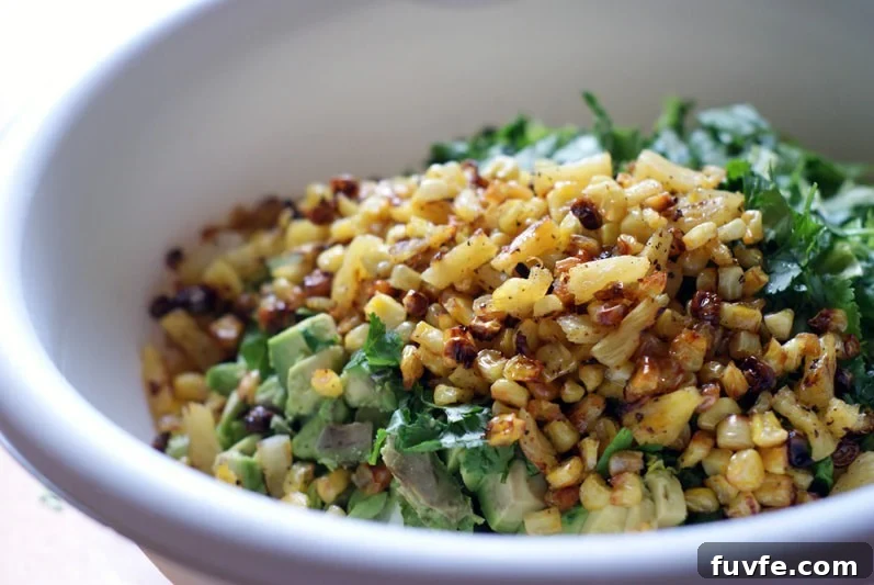 Quick Chicken Chopped Salad with BBQ and corn and pineapple in a large white bowl.