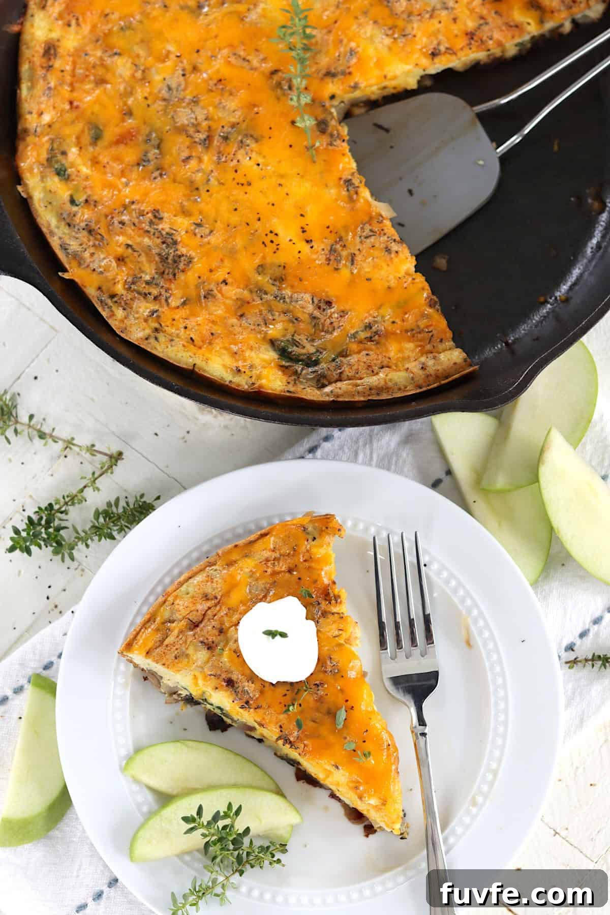 Apple Cheddar Frittata with Caramelized Onions and Herbs 2 An oven safe skillet with baked apple cheddar cheese frittata.