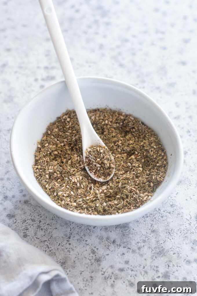 Za'atar seasoning in a bowl with a spoon