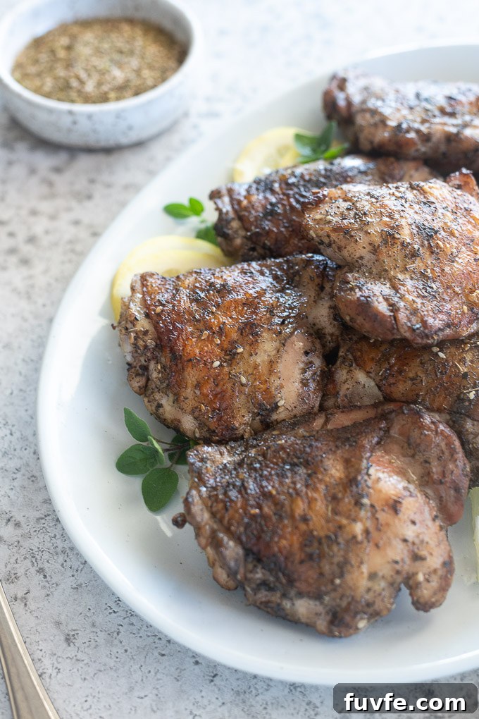 Juicy Grilled Chicken Thighs with Crispy Skin 7 Platter of za'atar grilled chicken thighs with a bowl of seasoning nearby