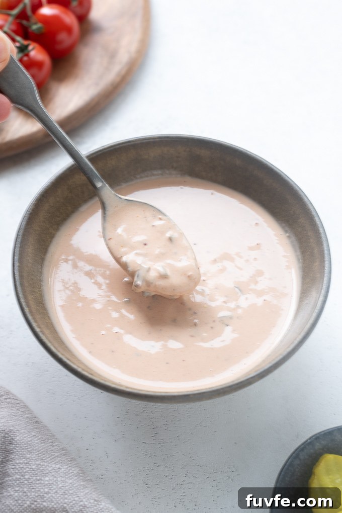 Creamy Tangy Burger Sauce Recipe for Juicy Burgers 7 Spoonful of homemade burger sauce over a bowl