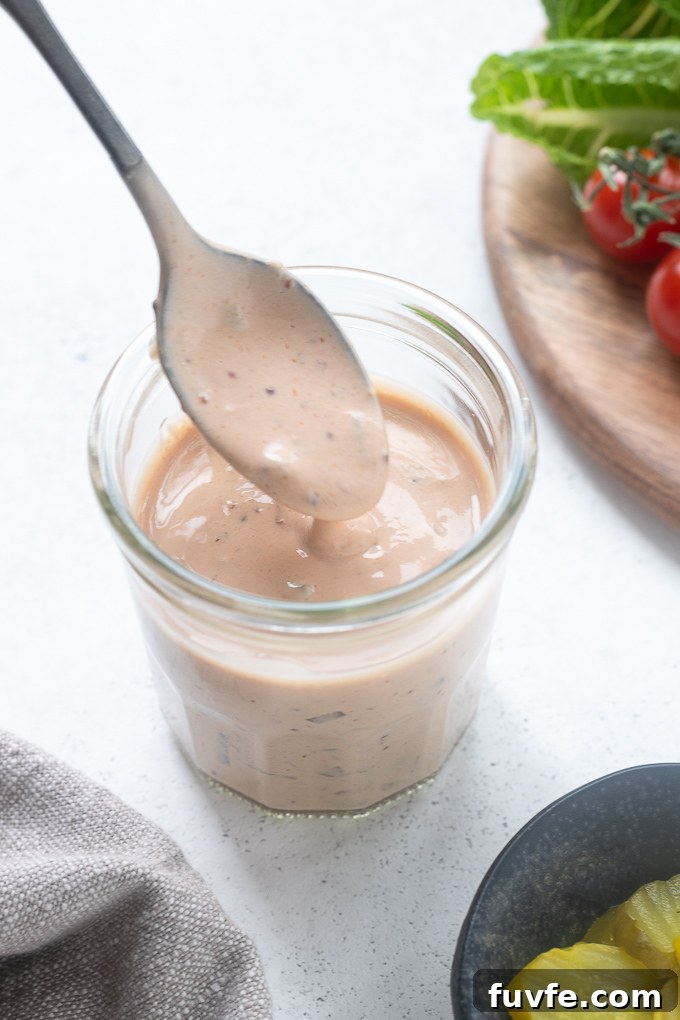 Creamy Tangy Burger Sauce Recipe for Juicy Burgers 8 Burger sauce drizzling from a spoon