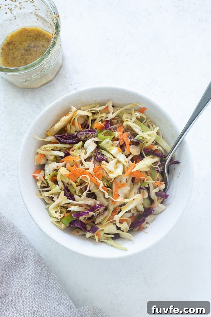 No Mayo Coleslaw in a white bowl with a fork
