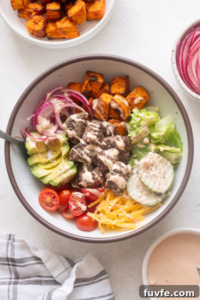Easy burger bowls with cheese, roasted sweet potatoes and burger sauce.
