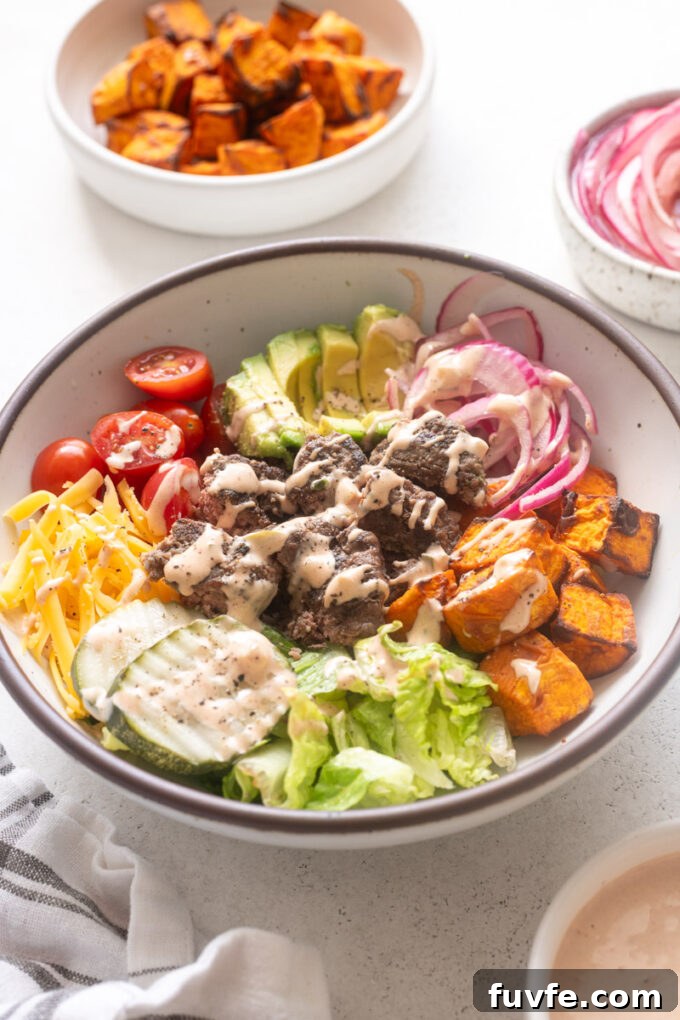 Easy burger bowls with sweet potatoes, pickled red onions and burger sauce.