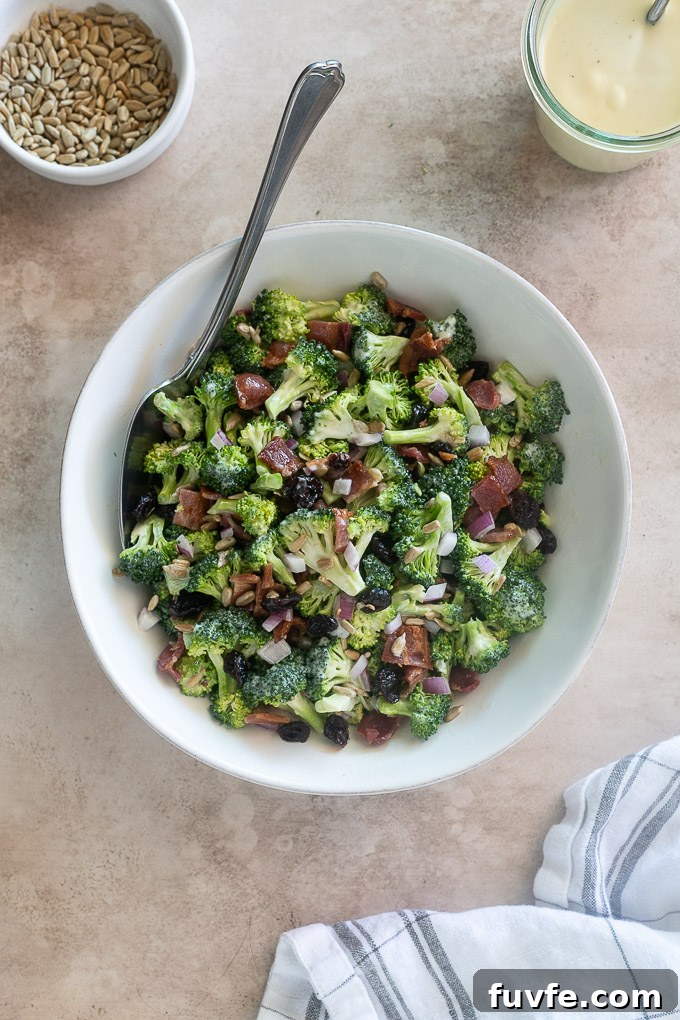 Broccoli salad with a serving spoon digging in