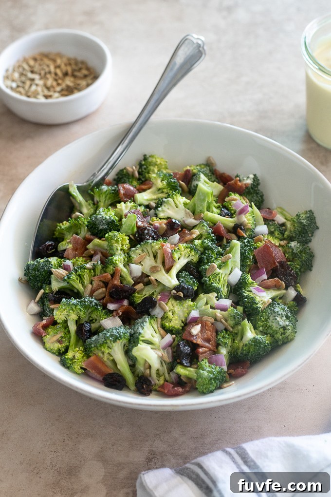 Crunchy Broccoli Salad with Bacon and Creamy Dressing 7 Easy broccoli salad in a bowl with a serving spoon