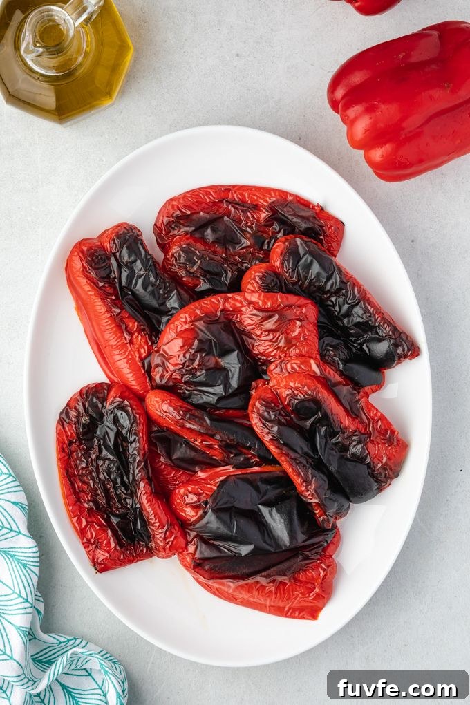 Charred roasted red peppers on a platter