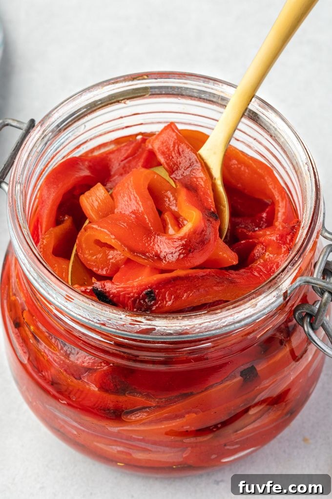 Oven roasted red peppers in a jar with olive oil