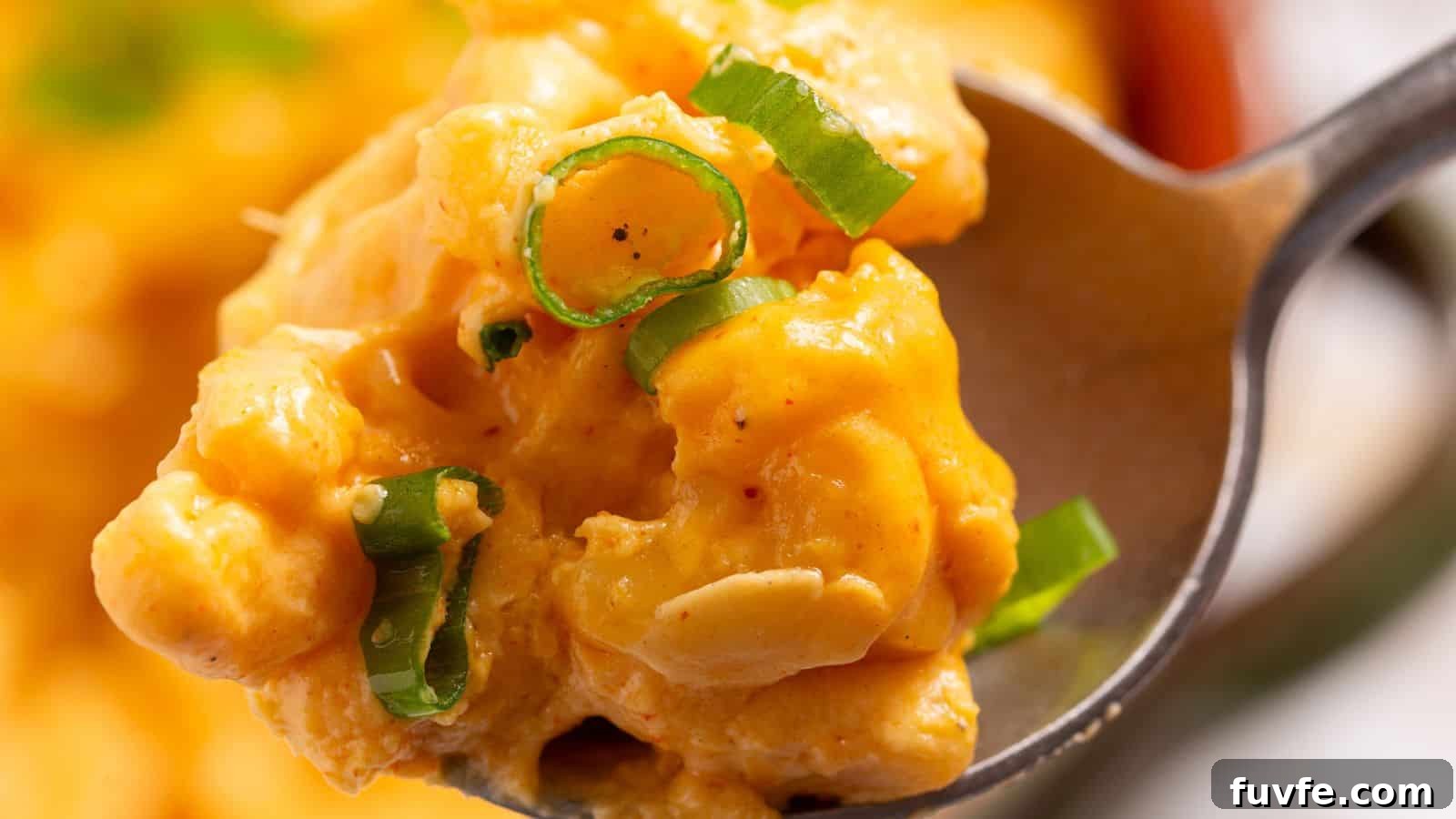 A bowl of macaroni and cheese in front of a slow cooker.