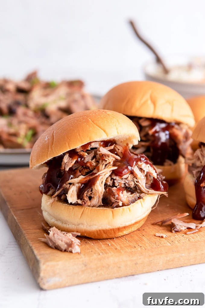Pulled pork sandwich on a cutting board with bbq sauce