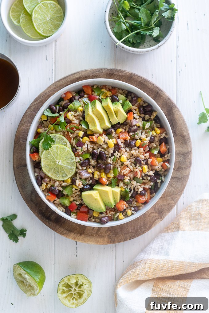 Southwest brown rice salad in a bowl with lime and avocado