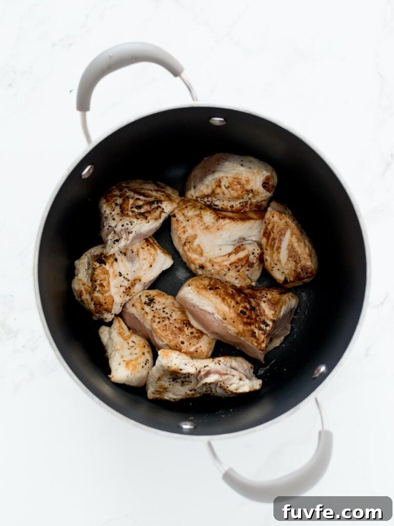 Creamy Chicken and Wild Rice Soup Recipe for Comforting Weeknights 4 seared chicken in soup pot