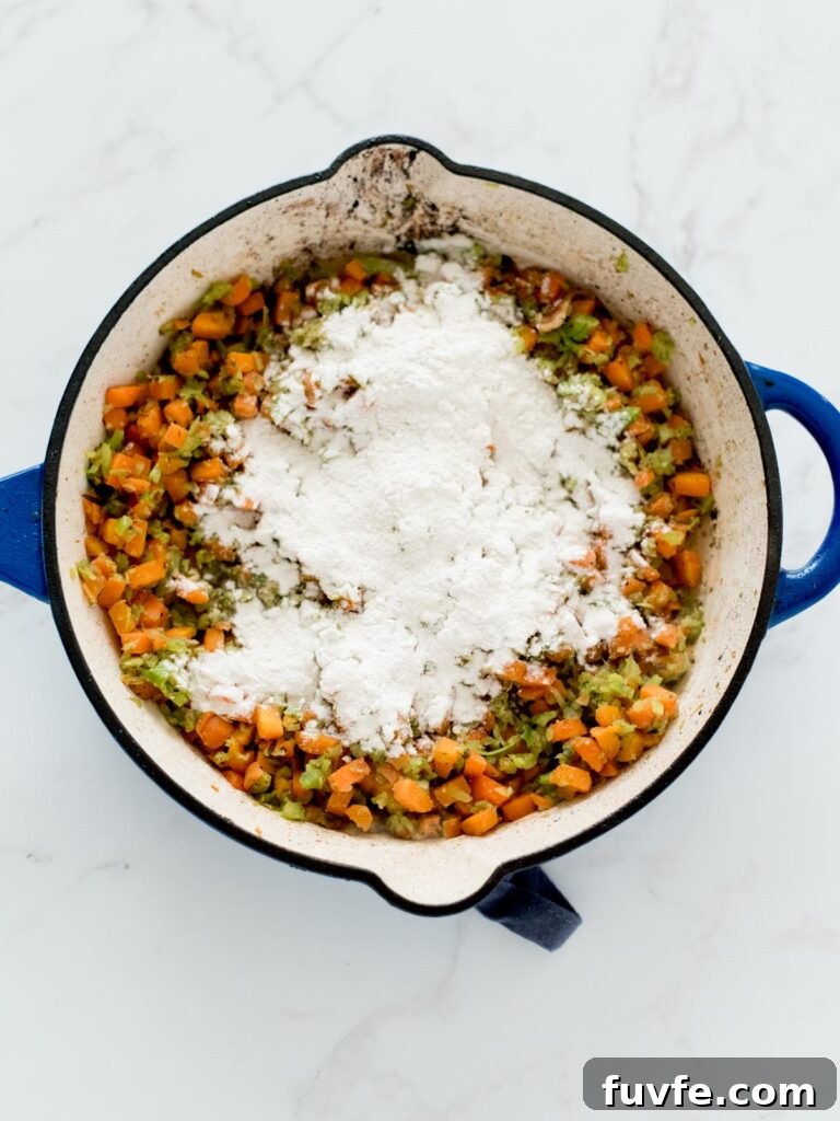 Creamy Chicken and Wild Rice Soup Recipe for Comforting Weeknights 7 sautéed vegetables in a skillet with flour