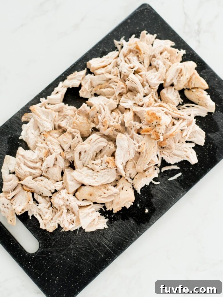Creamy Chicken and Wild Rice Soup Recipe for Comforting Weeknights 9 chopped chicken on a cutting board