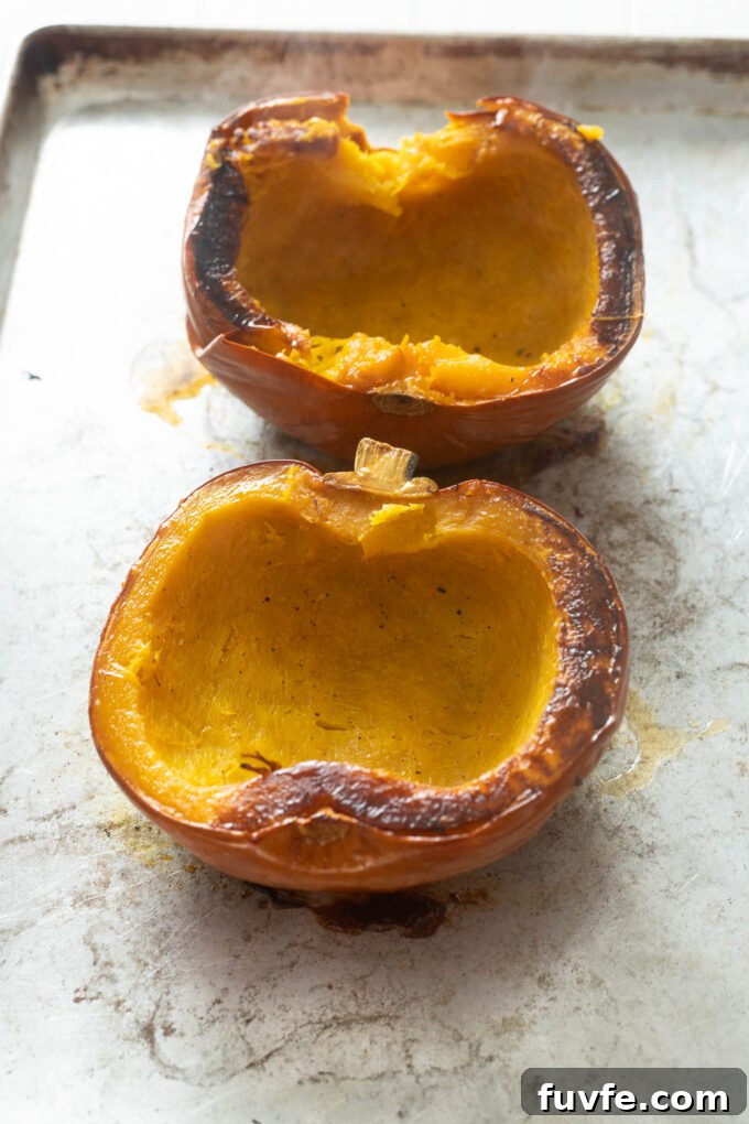 Whole roasted pumpkin on a baking sheet