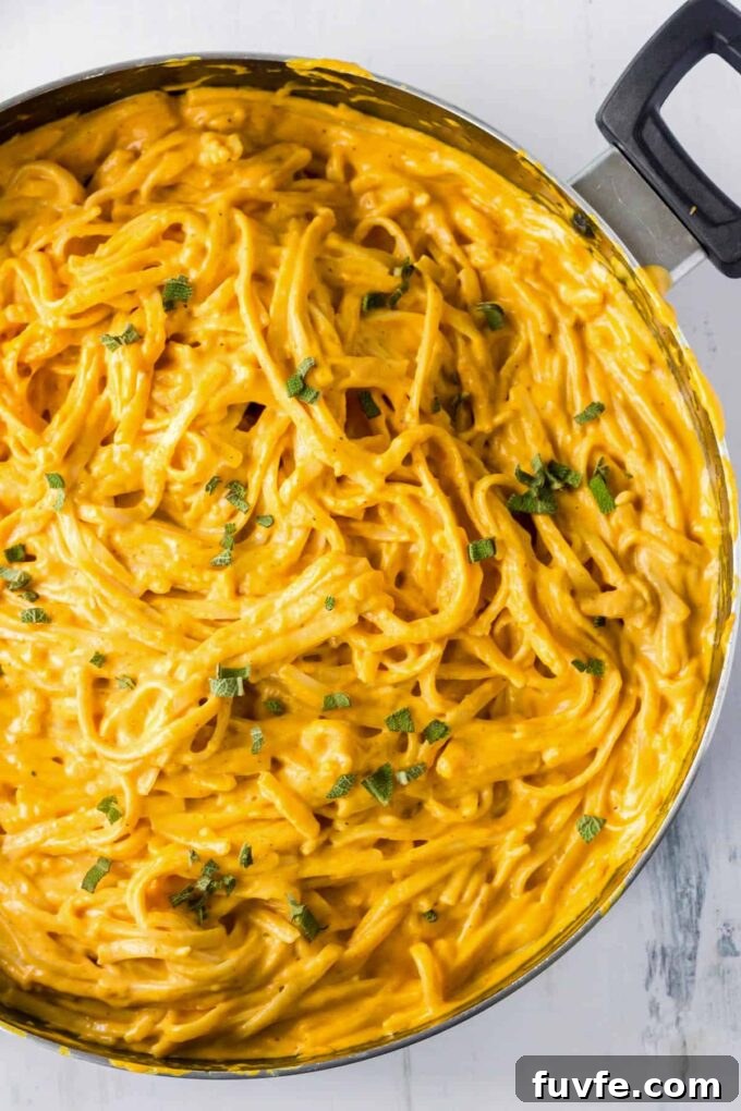 Pumpkin pasta sauce with pasta in a pan.