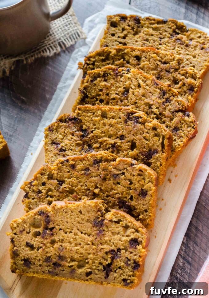 Chocolate Chip Pumpkin Bread sliced on a cutting board.