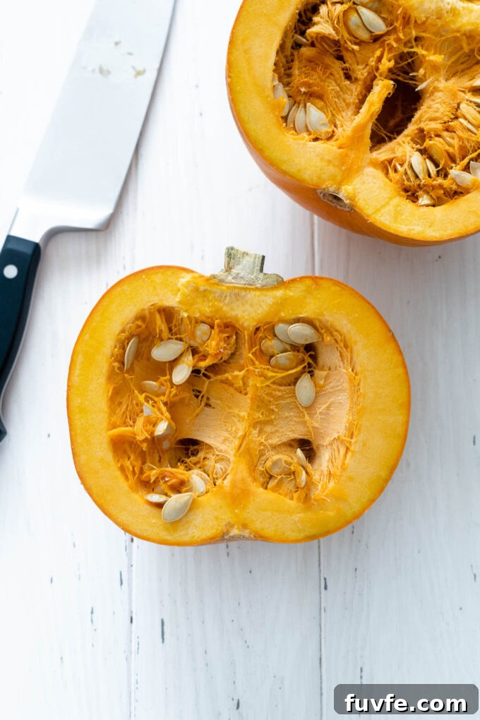 How to Cut a Pumpkin for Carving and Cooking 8 Halved pumpkin with knife nearby