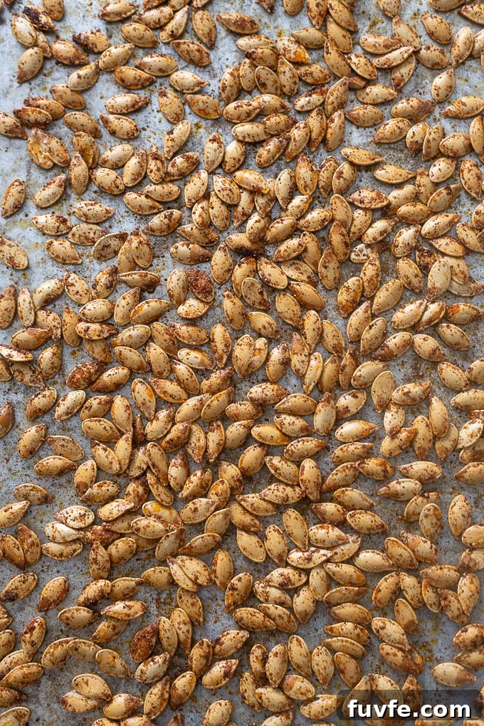 Oven roasted pumpkin seeds on a baking sheet