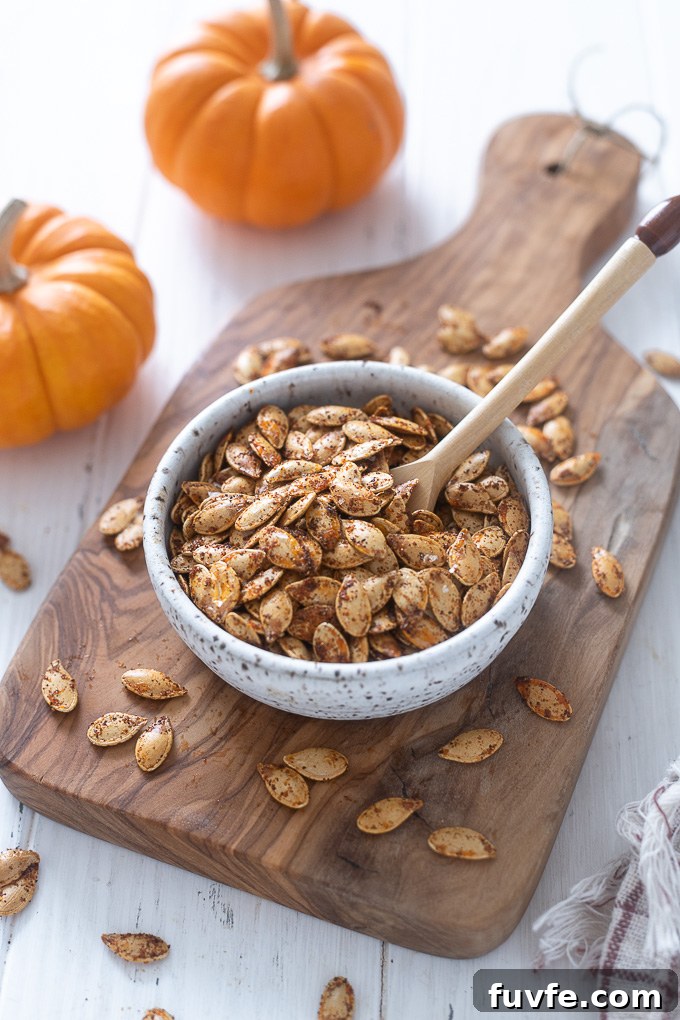Roasted pumpkin seeds in a bowl with a spoon