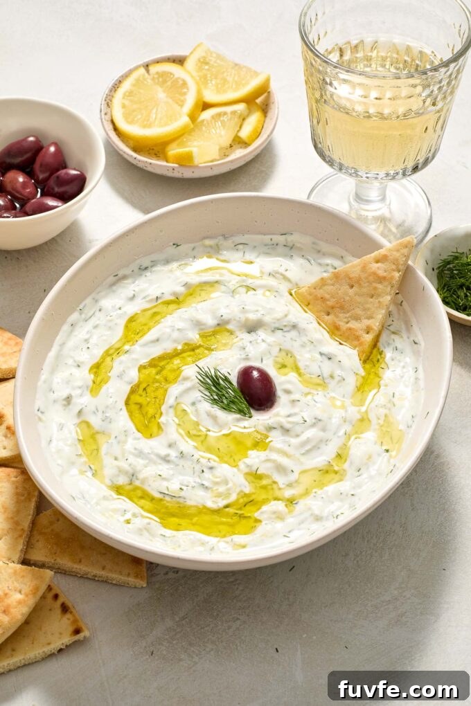 Authentic Greek Tzatziki: Creamy Cucumber-Yogurt Sauce 3 Easy Greek tzatziki in a bowl drizzled with olive oil.