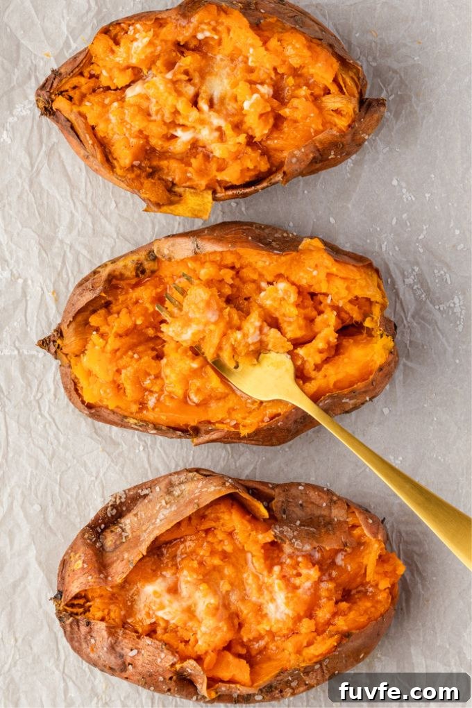 How to Bake Sweet Potatoes for Tender, Caramelized Flavor 3 Baked sweet potatoes with fork digging into middle one