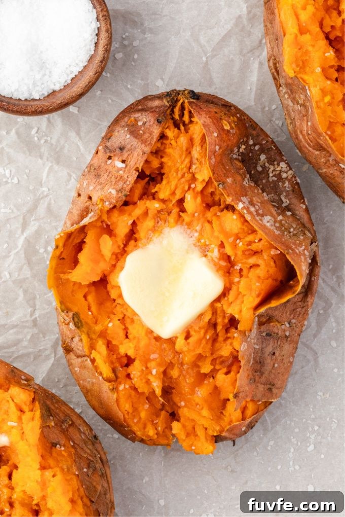 How to Bake Sweet Potatoes for Tender, Caramelized Flavor 6 Baked sweet potato sliced open with pat of butter