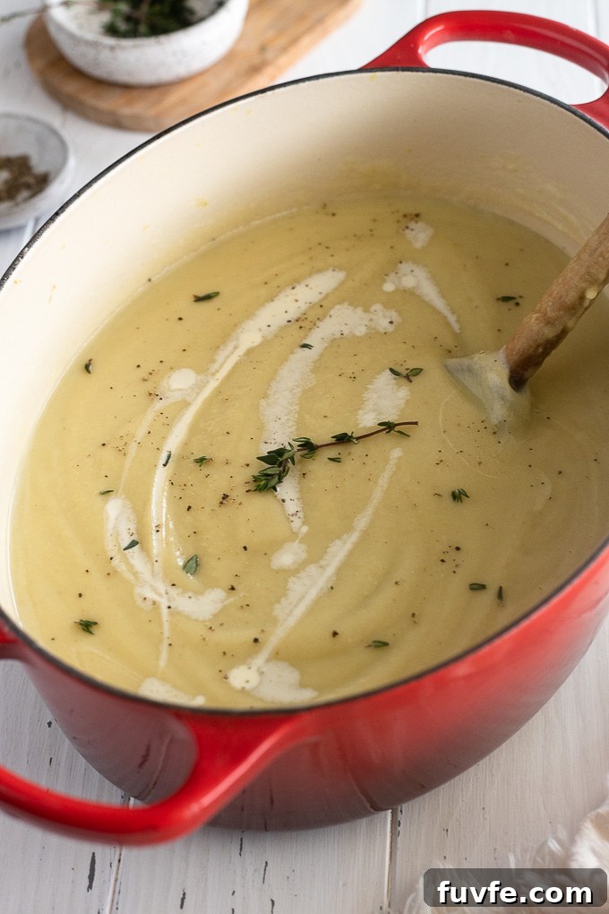 Creamy Roasted Parsnip Soup with Thyme 6 Creamy parsnip soup in a Dutch oven with cream and thyme